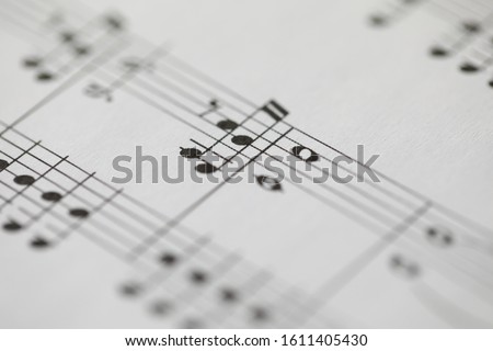 Musical notes printed on paper sheet close-up