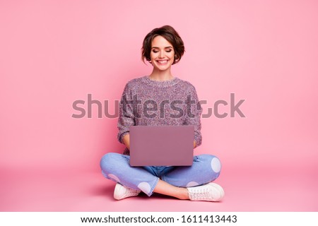 Portrait of her she nice attractive lovely charming pretty cute cheerful cheery brown-haired girl sitting in lotus pose using laptop typing e-mail isolated over pink pastel color background