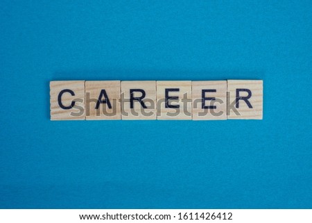  gray word career from small wooden letters on a blue table