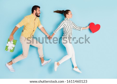 Top view above high angle flat lay flatlay lie concept full length body size view of nice couple running wedding holding hands isolated on bright vivid shine vibrant blue turquoise color background