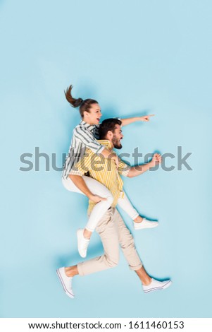Vertical top view above high angle flat lay flatlay lie concept full length body size view of cheerful couple running hurry-up isolated on bright vivid shine vibrant blue turquoise color background