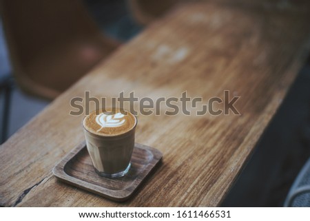 coffee latte art tulip on wood table 
in coffee shop  Royalty-Free Stock Photo #1611466531