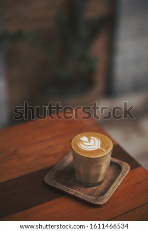 coffee latte art tulip on wood table 
in coffee shop  Royalty-Free Stock Photo #1611466534
