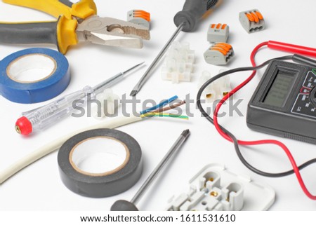 Electrician tools and instruments on a white background, close-up.
