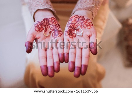 Very beautiful and unique henna paintings are on both hands of the bride.