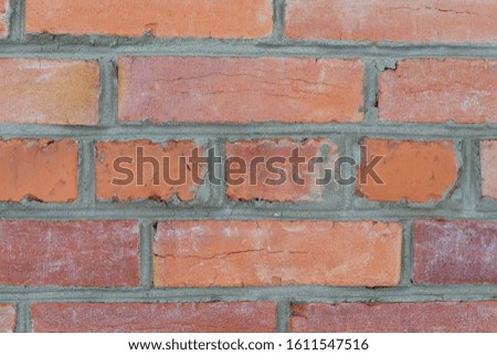 Weathered stained old brick wall background. Close up