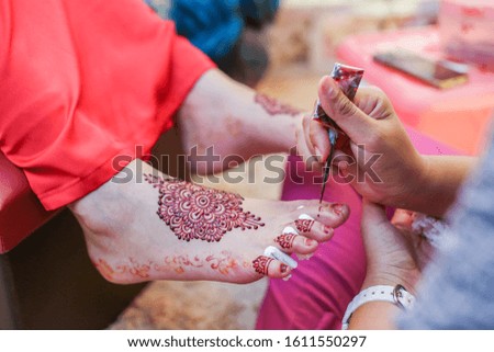 Very beautiful and unique henna paintings are on both legs of the bride.