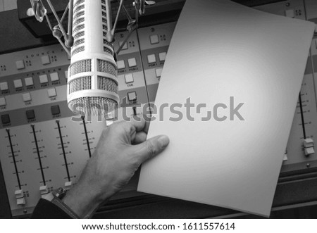Professional microphone and sound mixer. Hand holding empty paper