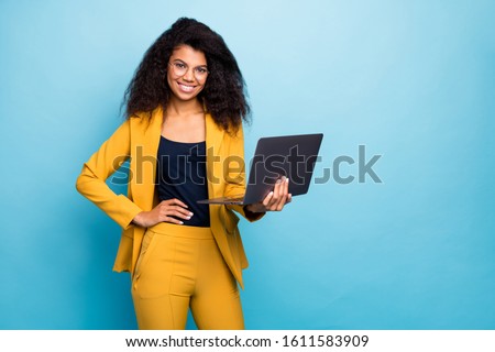 Photo of pretty assistant dark skin wavy lady holding notebook search information internet help boss friendly worker wear specs yellow suit blazer pants isolated blue color background