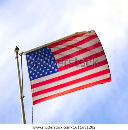 big  American flag hanging on a building 