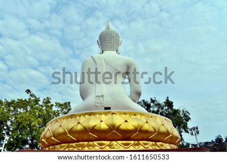 Back of big Buddha statue at temple and blue sky background. Buddha statue in Paknam Langsuan, Chumphon provinces, Thailand.