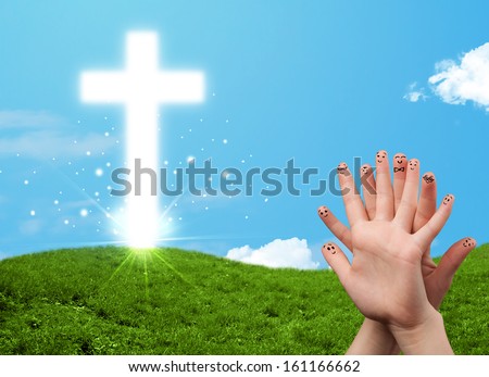 Happy finger smiley faces on hand with christian religion cross