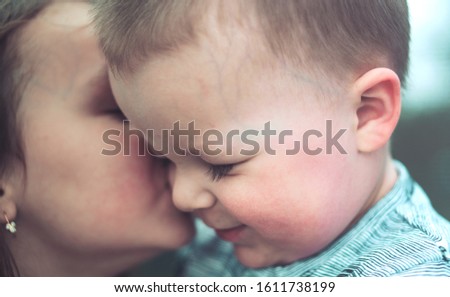 sister kissing confused little brother