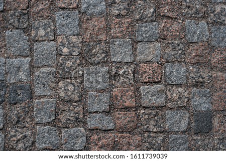 Abstract background of old cobblestone pavement. Close-up