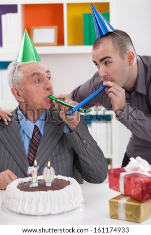 Senior father celebrating 70th birthday with his son 