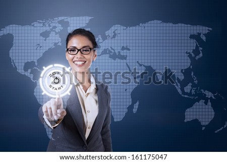 Young businesswoman touching futuristic touchscreen on blue world map background