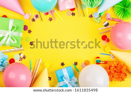 Birthday decor on yellow background, top view. Flat lay style. Mockup, template