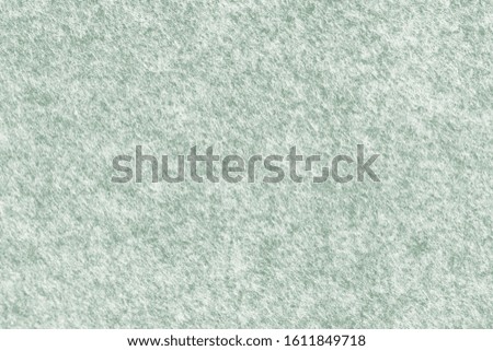 Green grey felt material. Surface of felted fabric texture abstract background. High resolution photo.