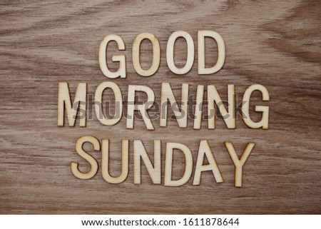 Good Morning Sunday text message on wooden background