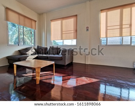 yellow roller blinds, shutter to protect sunlight, curtains blocking the sunlight in the living room that shines on the wooden floor. Royalty-Free Stock Photo #1611898066
