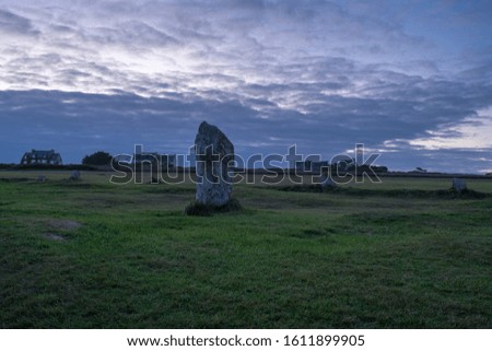 Scenic view of the sunset over collection of megalithic sites in Brittany in northwestern France.