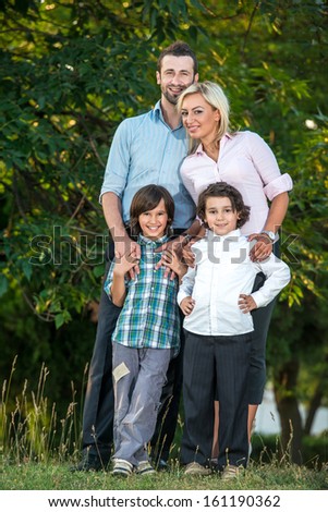 Portrait of a joyful family standing outside
