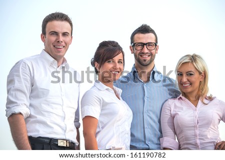 Group of happy modern corporate looking people posing