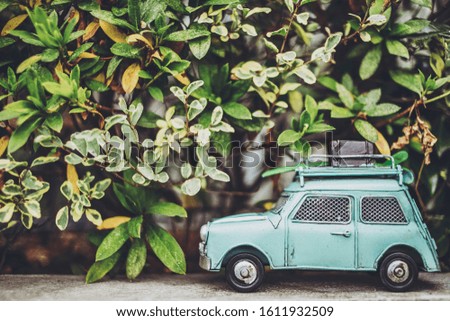Outdoor background with green miniature car