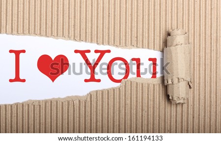 I love you text on white paper with copy space and torn cardboard
