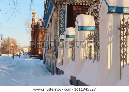 Russian winter city. Winter photo of the city. Beautiful old buildings. Patterns on the buildings. Frosty day. Beautiful architecture.