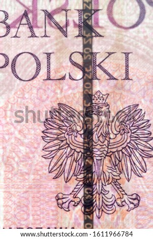 Plastic security strip inside 20 PLN banknote. Security strip on Polish banknote created to prevent counterfeiters.