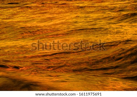 The sunset reflecting on the sea with crazy sea waves - great for wallpaper or background