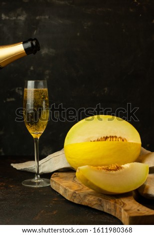 juicy yellow melon with a glass of champagne