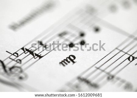 Musical notes printed on paper sheet close-up