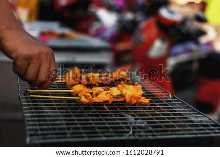 Pictures of grilled squid vendors on the street