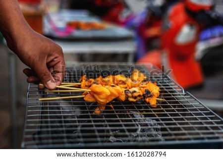 Pictures of grilled squid vendors on the street