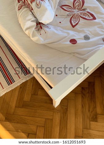 Bed corner and bed mat on the parquet