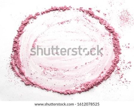 Vibrant pink powder and blush traces forming a round frame. A circle template for a makeup fashion business card, flyer, poster design with copy space