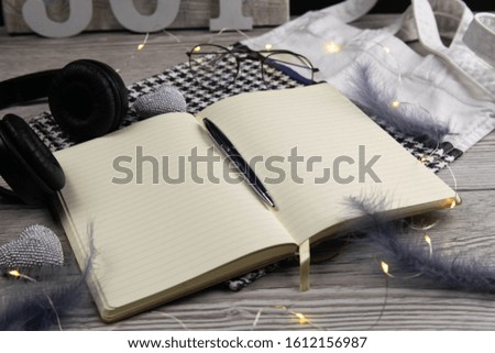 Leather handbag, clean blank notepad, pen, glasses, watch on a wooden background, top view. Free space for text. Workplace business background