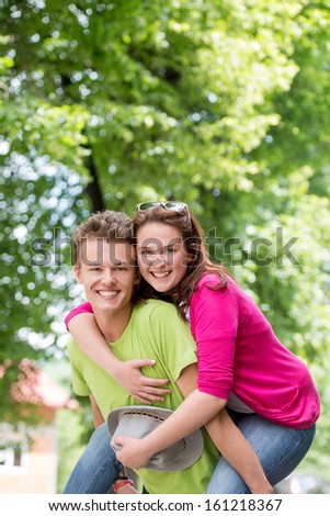 Happy young couple posing in nature