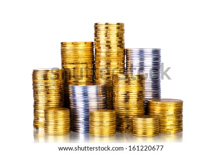 Towers made out of gold and silver coins over white background 