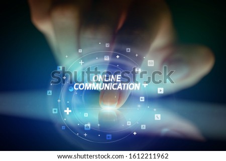 Finger touching tablet with social media icons and ONLINE COMMUNICATION
