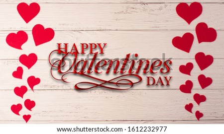 Holiday background for Valentine's Day on a white wooden background with felt carved hearts with place for text.