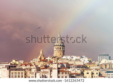 Galata Tower or Galata Kulesi in Istanbul after Rain with Rainbow on Sky, Turkey, Toned Picture