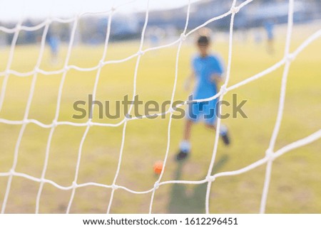 Soccer football net and blurry kids