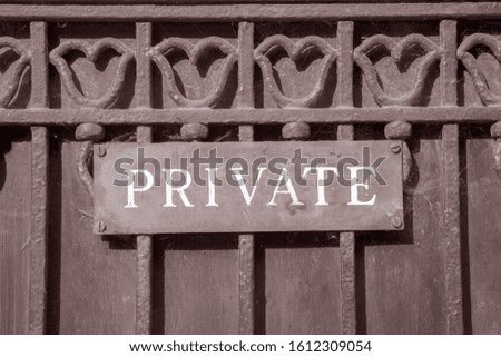 Private Sign on Metal Gate in Black and White Sepia Tone