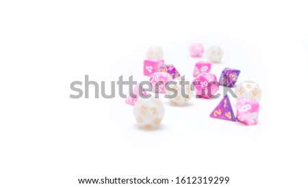 Dice polyhedral for tabletop RPG and Dungeons and Dragons. Pink, purple and white dice up to d20 on a white background. Minimalist and simple style.