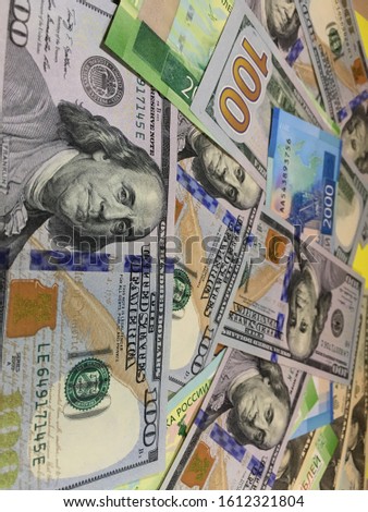 Background of hundred dollar bills close up and Russian money
