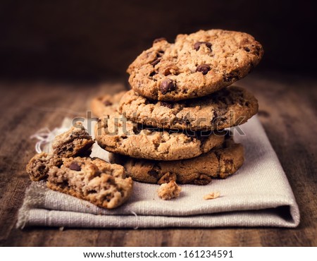 Chocolate chip cookies on linen napkin on wooden table. Stacked chocolate chip cookies close up. Royalty-Free Stock Photo #161234591