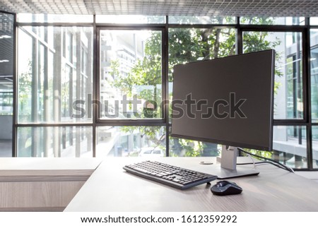 Work space and black screen desktop computer.  Desktop computer, home office accessories on wood desk. Royalty-Free Stock Photo #1612359292